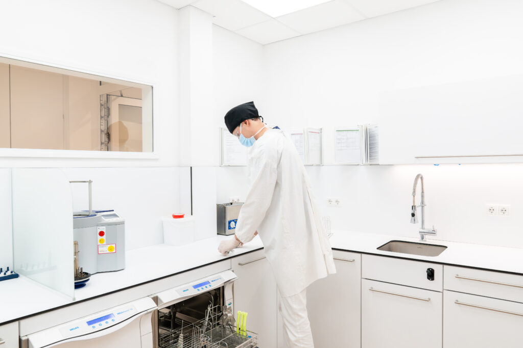 Mitarbeiter der Zahnklinik Nordhorn bei der Instrumentenaufbereitung im Sterilisationsraum – hygienische und professionelle Aufbereitung medizinischer Geräte.